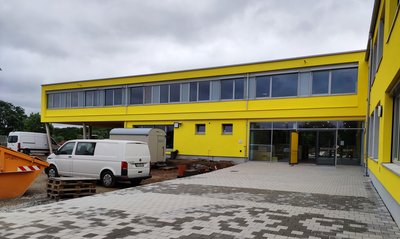 Blick auf ein modernes gelbes Schulgebäude 
